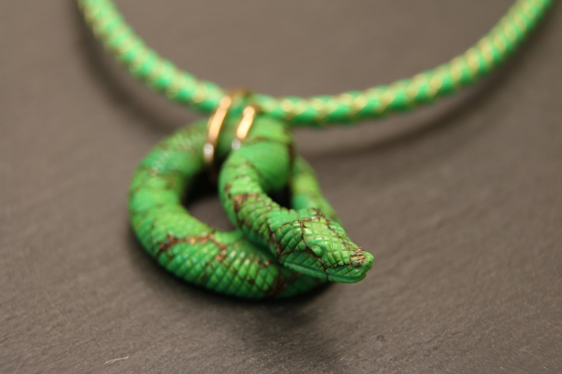 Serpente scolpito in un Turchese naturale iraniano con inclusioni di Rame e gancio in Oro Rosa 750